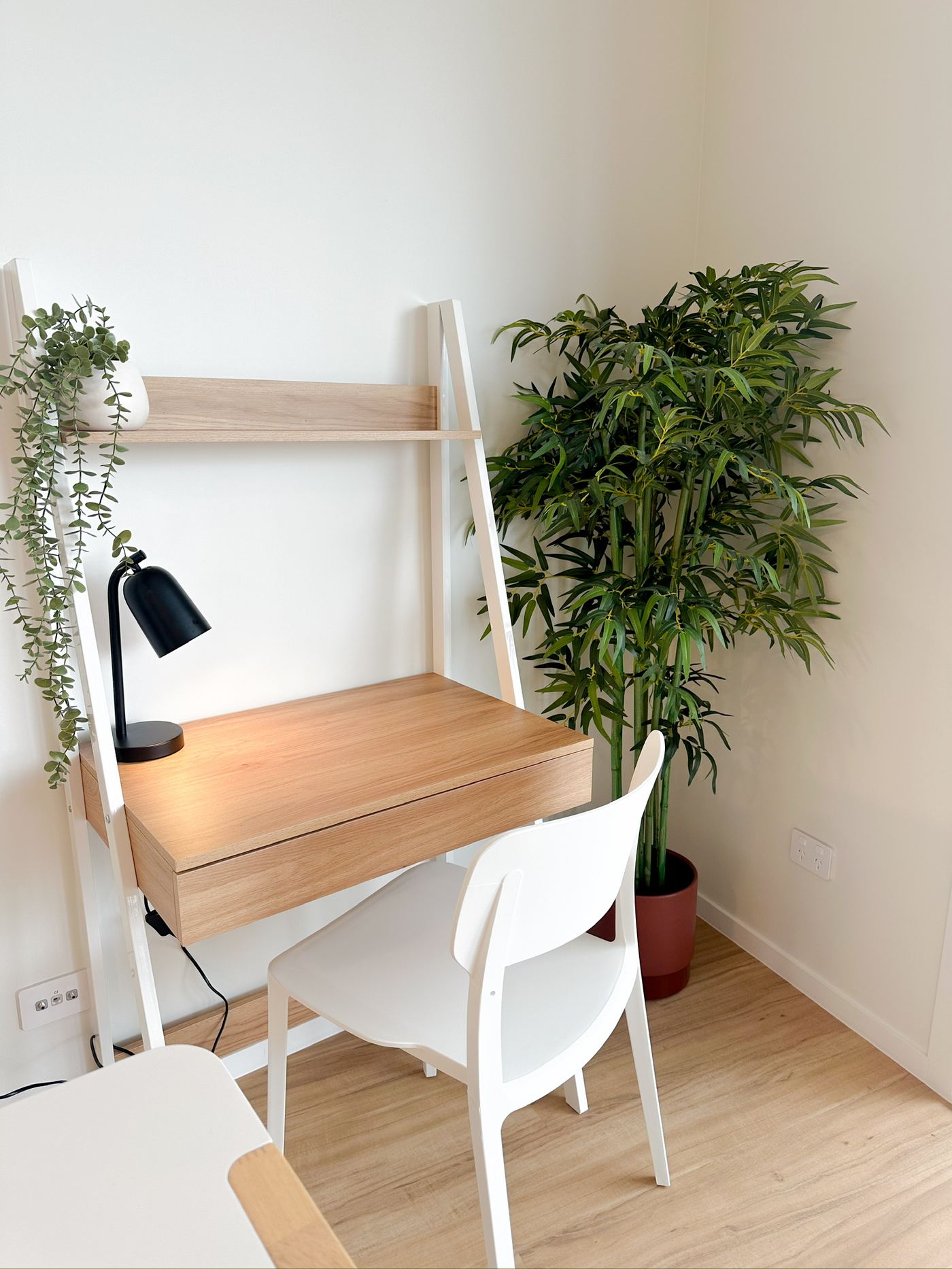 Study nook with desk, lamp and pot plants
