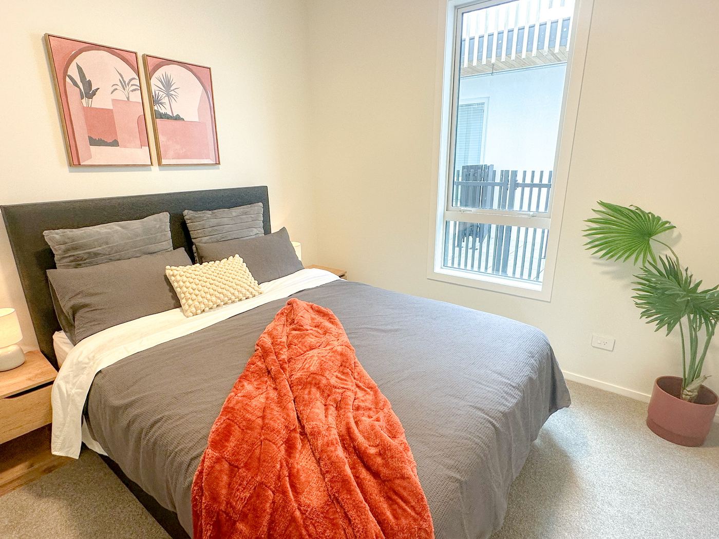 Bedroom queen bed with window overlooking the courtyard